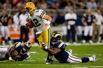 ST. LOUIS, MO - SEPTEMBER 27:  Aaron Rodgers #12 of the Green Bay Packers scrambles against Leonard Little #91 of the St. Louis Rams during the game at the Edward Jones Dome on September 27, 2009 in St. Louis, Missouri.  (Photo by Dilip Vishwanat/Getty Images)
