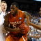 GREENSBORO, NC - MARCH 21: Damion James #5 of the Texas Longhorns drives between Kyle Singler #12 and Nolan Smith #2 of the Duke Blue Devils during the second round of the NCAA Division I Men's Basketball Tournament at the Greensboro Coliseum on March 21, 2009 in Greensboro, North Carolina. (Photo by Streeter Lecka/Getty Images)