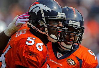 DENVER - OCTOBER 04:  Linebacker Robert Ayers #56 of the Denver Broncos celebrates with Darrell Reid #95 after a defensive play against the Dallas Cowboys during NFL action at Invesco Field at Mile High on October 4, 2009 in Denver, Colorado. The Broncos defeated the Cowboys 17-10.  (Photo by Doug Pensinger/Getty Images)