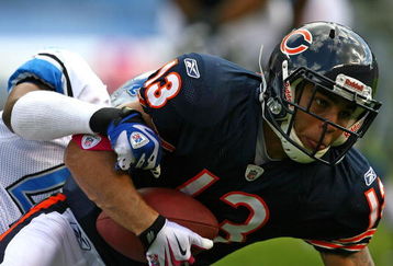 CHICAGO - OCTOBER 04: Johnny Knox #13 of the Chicago Bears tries to get away from a Detroit Lion defender on October 4, 2009 at Soldier Field in Chicago, Illinois. The Bears defeated the Lions 48-24. (Photo by Jonathan Daniel/Getty Images)