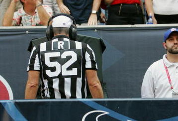 HOUSTON - OCTOBER 3:  Referee Bill Vinovich #52 reviews a play during the game between the Oakland Raiders and the Houston Texans on October 3, 2004 at Reliant Stadium in Houston, Texas.  (Photo by Ronald Martinez/Getty Images)