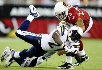 GLENDALE, AZ - AUGUST 22:  Running back LaDainian Tomlinson #21 of the San Diego Chargers trips as he carries the ball  for a 5 yard gain in the second quarter against Corner back Matt Ware #22 of the Arizona Cardinalsat the University of Phoenix Stadium on August 22, 2009 in Glendale, Arizona. (Photo by Christian Petersen/Getty Images)