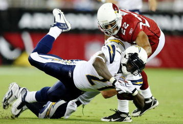 GLENDALE, AZ - AUGUST 22:  Running back LaDainian Tomlinson #21 of the San Diego Chargers trips as he carries the ball  for a 5 yard gain in the second quarter against Corner back Matt Ware #22 of the Arizona Cardinalsat the University of Phoenix Stadium on August 22, 2009 in Glendale, Arizona. (Photo by Christian Petersen/Getty Images)