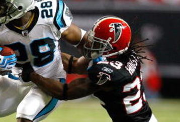 ATLANTA - SEPTEMBER 20:  Jonathan Stewart #28 of the Carolina Panthers tries to break a tackle by Chris Houston #23 of the Atlanta Falcons at Georgia Dome on September 20, 2009 in Atlanta, Georgia.  (Photo by Kevin C. Cox/Getty Images)