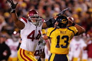 BERKELEY, CA - OCTOBER 03:  Kevin Riley #13 of the California Golden Bears is pressured by Christian Tupou #44 of the USC Trojans at California Memorial Stadium on October 3, 2009 in Berkeley, California.  (Photo by Ezra Shaw/Getty Images)