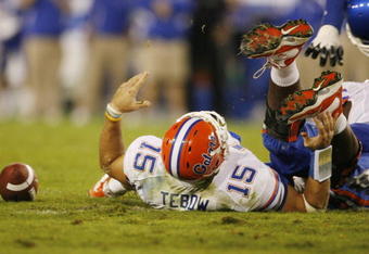 LEXINGTON, KY - SEPTEMBER 26: Quarterback Tim Tebow #15 of the Florida Gators lays on the ground after being sacked by Taylor Wyndham #94 of the Kentucky Wildcats during the third quarter of the game at Commonwealth Stadium on September 26, 2009 in Lexington, Kentucky. (Photo by Andy Lyons/Getty Images)
