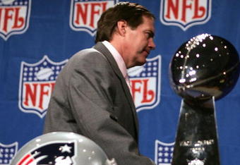 JACKSONVILLE, FL - FEBRUARY 4:  Bill Belichick, head coach of the New England Patriots, walks past the Vince Lombardi trophy after refusing to pose with it at a pre Superbowl press conference February 4, 2005 at the Prime F. Osborn Convention Center in Jacksonville, Florida.  (Photo by Al Bello/Getty Images)