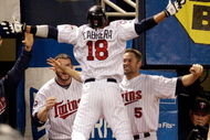 MINNEAPOLIS - OCTOBER 06: Orlando Cabrera #18 of the Minnesota Twins is congratulated by teammates after hitting a home run against starting pitcher Rick Porcello # 48 of the Detroit Tigers during the 7th inning of the American League Tiebreaker game on October 6, 2009 at Hubert H. Humphrey Metrodome in Minneapolis, Minnesota. (Photo by Jamie Squire/Getty Images)