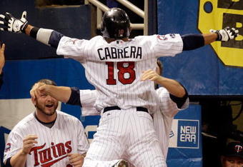 MINNEAPOLIS - OCTOBER 06:  Orlando Cabrera #18 of the Minnesota Twins is congratulated by teammates after hitting a home run against starting pitcher Rick Porcello # 48 of the Detroit Tigers during the 7th inning of the American League Tiebreaker game on October 6, 2009 at Hubert H. Humphrey Metrodome in Minneapolis, Minnesota.  (Photo by Jamie Squire/Getty Images)
