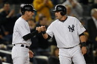 NEW YORK - SEPTEMBER 30: Francisco Cervelli #29 is congratulated by third base coach Rob Thomson #59 of the New York Yankees in the 9th inning during the game against the Kansas City Royals on September 30, 2009 at Yankee Stadium in the Bronx borough of New York City. (Photo by Jared Wickerham/Getty Images)