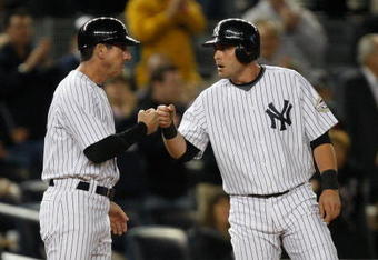NEW YORK - SEPTEMBER 30: Francisco Cervelli #29 is congratulated by third base coach Rob Thomson #59 of the New York Yankees in the 9th inning during the game against the Kansas City Royals on September 30, 2009 at Yankee Stadium in the Bronx borough of New York City. (Photo by Jared Wickerham/Getty Images)