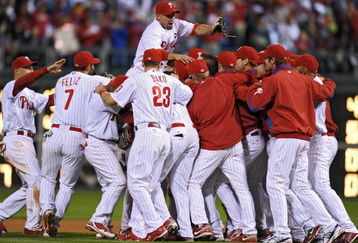 PHILADELPHIA - SEPTEMBER 30: Shane Victorino #8 of the Philadelphia Phillies jumps on top of his teammates after beating the Houston Astros 10-3 and winning the National League East on September 30, 2009 at Citizens Bank Park in Philadelphia, Pennsylvania. (Photo by Drew Hallowell/Getty Images)