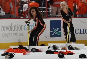 PHILADELPHIA - OCTOBER 06:  The ice crew removes hats from the ice following a second period hattrick by Mike Richards #18 of the Philadelphia Flyers in their game against the Washington Capitals at the Wachovia Center on October 6, 2009 in Philadelphia, Pennsylvania.  (Photo by Bruce Bennett/Getty Images)