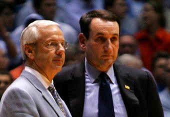 CHAPEL HILL, NC - MARCH 04:  Head coach Mike Krzyzewski (R) of the Duke Blue Devils waits on the officials with head coach Roy Williams of the University of North Carolina Tar Heels after an incident involving Tyler Hansbrough and Gerald Henderson during their game at the Dean E. Smith Center on March 4, 2007 in Chapel Hill, North Carolina. North Carolina defeated Duke, 86 - 72.  (Photo by Streeter Lecka/Getty Images)
