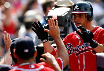 ATLANTA - AUGUST 23:  Omar Infante #4 of the Atlanta Braves celebrates in the dugout after scoring in the bottom of the eighth inning against the Florida Marlins on August 23, 2009 at Turner Field in Atlanta, Georgia.  (Photo by Kevin C. Cox/Getty Images)