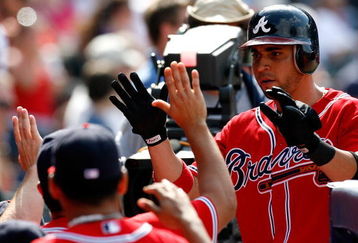 ATLANTA - AUGUST 23:  Omar Infante #4 of the Atlanta Braves celebrates in the dugout after scoring in the bottom of the eighth inning against the Florida Marlins on August 23, 2009 at Turner Field in Atlanta, Georgia.  (Photo by Kevin C. Cox/Getty Images)