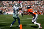 DENVER - OCTOBER 04:  Roy Williams #11 of the Dallas Cowboys makes a pass reception and is pushed out of bounds by Champ Bailey #24 of the Denver Broncos in the first quarter during NFL action at Invesco Field at Mile High on October 4, 2009 in Denver, Colorado.  (Photo by Doug Pensinger/Getty Images)