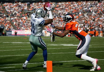 DENVER - OCTOBER 04:  Roy Williams #11 of the Dallas Cowboys makes a pass reception and is pushed out of bounds by Champ Bailey #24 of the Denver Broncos in the first quarter during NFL action at Invesco Field at Mile High on October 4, 2009 in Denver, Colorado.  (Photo by Doug Pensinger/Getty Images)