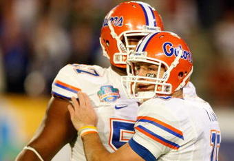 MIAMI - JANUARY 08:  Tim Tebow #15 (R) and Carl Johnson #57 of the Florida Gators celebrate after Tebow threw a 20-yard touchdown pass to Louis Murphy #9 in the second quarter against the Oklahoma Sooners during the FedEx BCS National Championship game at Dolphin Stadium on January 8, 2009 in Miami, Florida.  (Photo by Marc Serota/Getty Images)