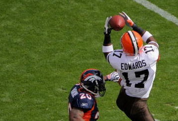 DENVER - SEPTEMBER 20:  Braylon Edwards #17 of the Cleveland Browns makes a reception as Brain Dawkins #20 and Renaldo Hill #23 of the Denver Broncos defend during NFL action at Invesco Field at Mile High on September 20, 2009 in Denver, Colorado. The Broncos defeated the Browns 27-6.  (Photo by Doug Pensinger/Getty Images)