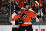 PHILADELPHIA - OCTOBER 06: Mike Richards #18 (L) of the Phildelphia Flyers is hugged by Chris Pronger #20 (R) after his second period goal against the Washington Capitals at the Wachovia Center on October 6, 2009 in Philadelphia, Pennsylvania.  (Photo by Bruce Bennett/Getty Images)