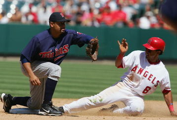 ANAHEIM, CA - JULY 6:   Maicer Izturis #6 of the Los Angeles Angels of Anaheim is safe at second base in the 7th inning against Luis Rivas #2 of the Minnesota Twins on July 6, 2005 at Angel Stadium in Anaheim, California.  The Angels won 7-6. (Photo by Lisa Blumenfeld/Getty Images)