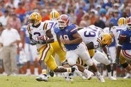 GAINESVILLE, FL - OCTOBER 7:   Wide receiver Craig Davis #3 of the LSU Tigers runs with the ball pursued by defensive lineman Javier Estopinan #48 of the Florida Gators at Ben Hill Griffin Stadium on October 7, 2006 in Gainesville, Florida. Florida won 23-10.  (Photo by Marc Serota/Getty Images)