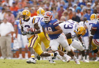 GAINESVILLE, FL - OCTOBER 7:   Wide receiver Craig Davis #3 of the LSU Tigers runs with the ball pursued by defensive lineman Javier Estopinan #48 of the Florida Gators at Ben Hill Griffin Stadium on October 7, 2006 in Gainesville, Florida. Florida won 23-10.  (Photo by Marc Serota/Getty Images)