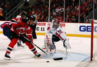 NEWARK, NJ - NOVEMBER 15:  Jose theodore #60 of the Washington Capitals defends the goal against Patrik Elias #26 of the New Jersey Devils during their game on November 15, 2008 at the Prudential Center in Newark, New Jersey  (Photo by Al Bello/Getty Images)