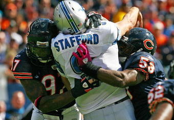 CHICAGO - OCTOBER 04: Mark Anderson #97 and Nick Roach #53 of the Chicago Bears hit Matthew Stafford #9 of the Detroit Lions after a pass on October 4, 2009 at Soldier Field in Chicago, Illinois. The Bears defeated the Lions 48-24. (Photo by Jonathan Daniel/Getty Images)