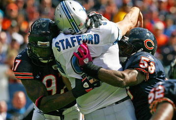 CHICAGO - OCTOBER 04: Mark Anderson #97 and Nick Roach #53 of the Chicago Bears hit Matthew Stafford #9 of the Detroit Lions after a pass on October 4, 2009 at Soldier Field in Chicago, Illinois. The Bears defeated the Lions 48-24. (Photo by Jonathan Daniel/Getty Images)