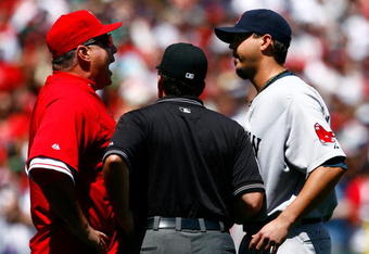 ANAHEIM, CA - APRIL 12:  Los Angeles Angels of Anaheim manager Mike Scioscia (L) is seperated by umpire Ed Rapuano while arguing with pitcher Josh Beckett #19 of the Boston Red Sox in the first inning at Angel Stadium on April 12, 2009 in Anaheim, California.  The Angels defeated the Red Sox 5-4.  (Photo by Jeff Gross/Getty Images)
