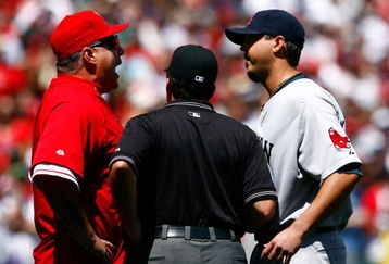 ANAHEIM, CA - APRIL 12:  Los Angeles Angels of Anaheim manager Mike Scioscia (L) is seperated by umpire Ed Rapuano while arguing with pitcher Josh Beckett #19 of the Boston Red Sox in the first inning at Angel Stadium on April 12, 2009 in Anaheim, California.  The Angels defeated the Red Sox 5-4.  (Photo by Jeff Gross/Getty Images)