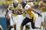 JACKSONVILLE, FL - JANUARY 01:  Running back Tashard Choice #22 of the Georgia Tech Yellow Jackets runs through nose tackle Keilen Dykes #96  of the West Virginia Mountaineers defense in the Toyota Gator Bowl at Alltel Stadium January 1, 2007 in Jacksonville, Florida.  (Photo by Marc Serota/Getty Images)