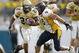 JACKSONVILLE, FL - JANUARY 01:  Running back Tashard Choice #22 of the Georgia Tech Yellow Jackets runs through nose tackle Keilen Dykes #96  of the West Virginia Mountaineers defense in the Toyota Gator Bowl at Alltel Stadium January 1, 2007 in Jacksonville, Florida.  (Photo by Marc Serota/Getty Images)