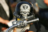 OAKLAND, CA - SEPTEMBER 14:  A mini biker helmet with a Oakland Raiders logo is seen on the handle bar of a motorcycle in the parking lot outside Oakland-Alameda County Coliseum prior to the Raiders playing against the San Diego Chargers against the Oakland Raiders on September 14, 2009 at the Oakland-Alameda County Coliseum in Oakland, California.  (Photo by Ezra Shaw/Getty Images)