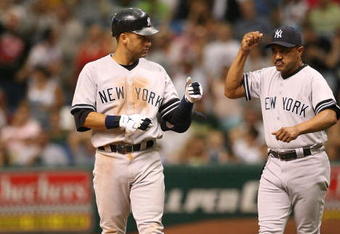 ST. PETERSBURG, FL - JULY 15:  Derek Jeter #2 of the New York Yankees is congratulated by first base coach Tony Pena #52 after Jeter drove in a run with an infield single in the eighth inning against the Tampa Bay Devil Rays on July 15, 2007 at Tropicana Field in St. Petersburg, Florida.  (Photo by Doug Benc/Getty Images)