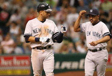 ST. PETERSBURG, FL - JULY 15:  Derek Jeter #2 of the New York Yankees is congratulated by first base coach Tony Pena #52 after Jeter drove in a run with an infield single in the eighth inning against the Tampa Bay Devil Rays on July 15, 2007 at Tropicana Field in St. Petersburg, Florida.  (Photo by Doug Benc/Getty Images)