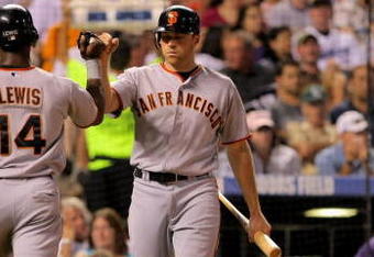 DENVER - JULY 24:  Fred Lewis #14 of the San Francisco Giants is welcomed home by teammate Nate Schierholtz #12 after Lewis scored on a single by Bengie Molina in the sixth inning against the Colorado Rockies at Coors Field on July 24, 2009 in Denver, Colorado. The Giants defeated the Rockies 3-1.  (Photo by Doug Pensinger/Getty Images)