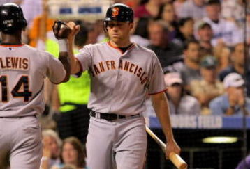 DENVER - JULY 24:  Fred Lewis #14 of the San Francisco Giants is welcomed home by teammate Nate Schierholtz #12 after Lewis scored on a single by Bengie Molina in the sixth inning against the Colorado Rockies at Coors Field on July 24, 2009 in Denver, Colorado. The Giants defeated the Rockies 3-1.  (Photo by Doug Pensinger/Getty Images)