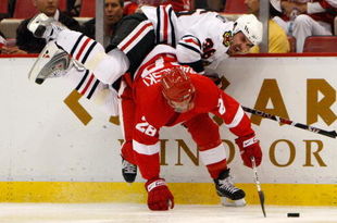 DETROIT - MAY 27:  Dave Bolland #36 of the Chicago Blackhawks falls over the top of Brian Rafalski #28 the Detroit Red Wings as Rafalski controls the puck during Game Five of the Western Conference Championship Round of the 2009 Stanley Cup Playoffs on May 27, 2009 at Joe Louis Arena in Detroit, Michigan.  (Photo by Gregory Shamus/Getty Images)
