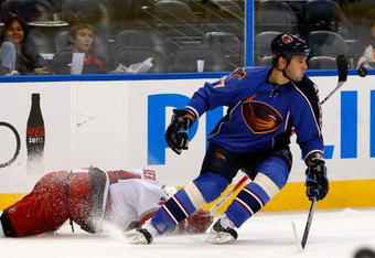 ATLANTA - SEPTEMBER 21:  Scott Walker #24 of the Carolina Hurricanes dives to knock the puck away from Pavel Kubina #77 of the Atlanta Thrashers during a preseason game at Philips Arena on September 21, 2009 in Atlanta, Georgia.  (Photo by Kevin C. Cox/Getty Images)
