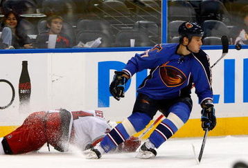 ATLANTA - SEPTEMBER 21:  Scott Walker #24 of the Carolina Hurricanes dives to knock the puck away from Pavel Kubina #77 of the Atlanta Thrashers during a preseason game at Philips Arena on September 21, 2009 in Atlanta, Georgia.  (Photo by Kevin C. Cox/Getty Images)