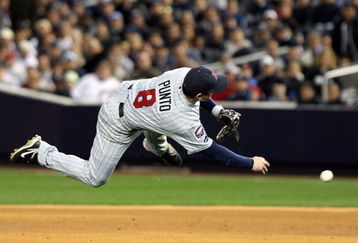 NEW YORK - OCTOBER 07:  Nick Punto #8 of the Minnesota Twins throws to first base to make an out against the New York Yankees in Game One of the ALDS during the 2009 MLB Playoffs at Yankee Stadium on October 7, 2009 in the Bronx borough of New York City.  (Photo by Nick Laham/Getty Images)