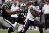 HOUSTON - OCTOBER 04:  Running back Steve Slaton #20 breaks loose from tackles by linebacker Ricky Brown #57 and cornerback Nnamdi Asomugha #21 of the Oakland Raiders at Reliant Stadium on October 4, 2009 in Houston, Texas.  (Photo by Bob Levey/Getty Images)