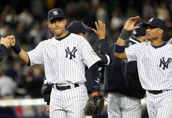 NEW YORK - OCTOBER 07:  Derek Jeter #2 and Robinson Cano #24 of the New York Yankees celebrate after defeating the Minnesota Twins to win Game One of the ALDS during the 2009 MLB Playoffs at Yankee Stadium on October 7, 2009 in the Bronx borough of New York City.  (Photo by Jim McIsaac/Getty Images)