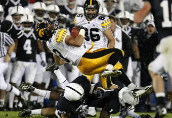 STATE COLLEGE, PA - SEPTEMBER 26:  Brandon Wegher #3 of the Iowa Hawkeyes is tackled by A.J. Wallace #1 and Drew Astorino #28 of the Penn State Nittnay Lions on September 26, 2009 at Beaver Stadium in State College, Pennsylvania. Iowa won the game 21-10.  (Photo by Gregory Shamus/Getty Images)