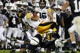 STATE COLLEGE, PA - SEPTEMBER 26:  Brandon Wegher #3 of the Iowa Hawkeyes is tackled by A.J. Wallace #1 and Drew Astorino #28 of the Penn State Nittnay Lions on September 26, 2009 at Beaver Stadium in State College, Pennsylvania. Iowa won the game 21-10.  (Photo by Gregory Shamus/Getty Images)