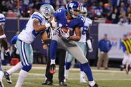 EAST RUTHERFORD, NJ - NOVEMBER 02:  Steve Smith #12 of the New York Giants scores a touchdown as Orlando Scandrick #32 of the Dallas Cowboys defends during their game on November 2, 2008 at Giants Stadium in East Rutherford, New Jersey.  (Photo by Al Bello/Getty Images)