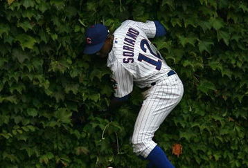 CHICAGO - AUGUST 28: Alfonso Soriano #12 of the Chicago Cubs hits the outfield wall after missing a catch against the New York Mets on August 28, 2009 at Wrigley Field in Chicago, Illinois. The Cubs defeated the Mets 5-2. (Photo by Jonathan Daniel/Getty Images)